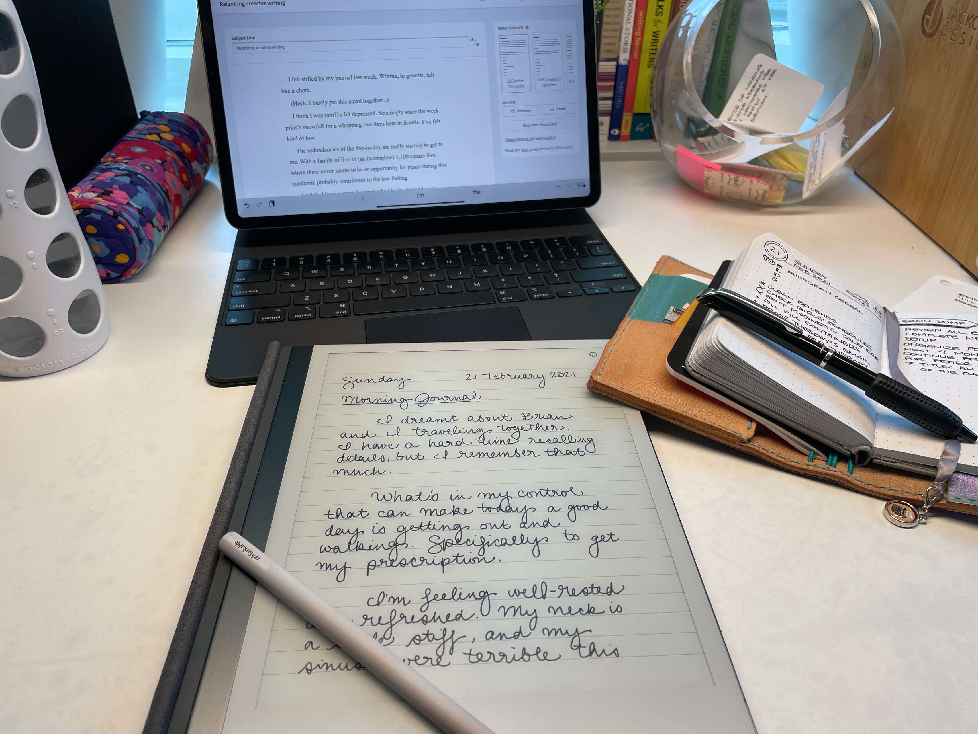 [ Photo of my previous workspace, including an iPad, reMarkable e-ink writing tablet, and a small bullet-journal notebook ]