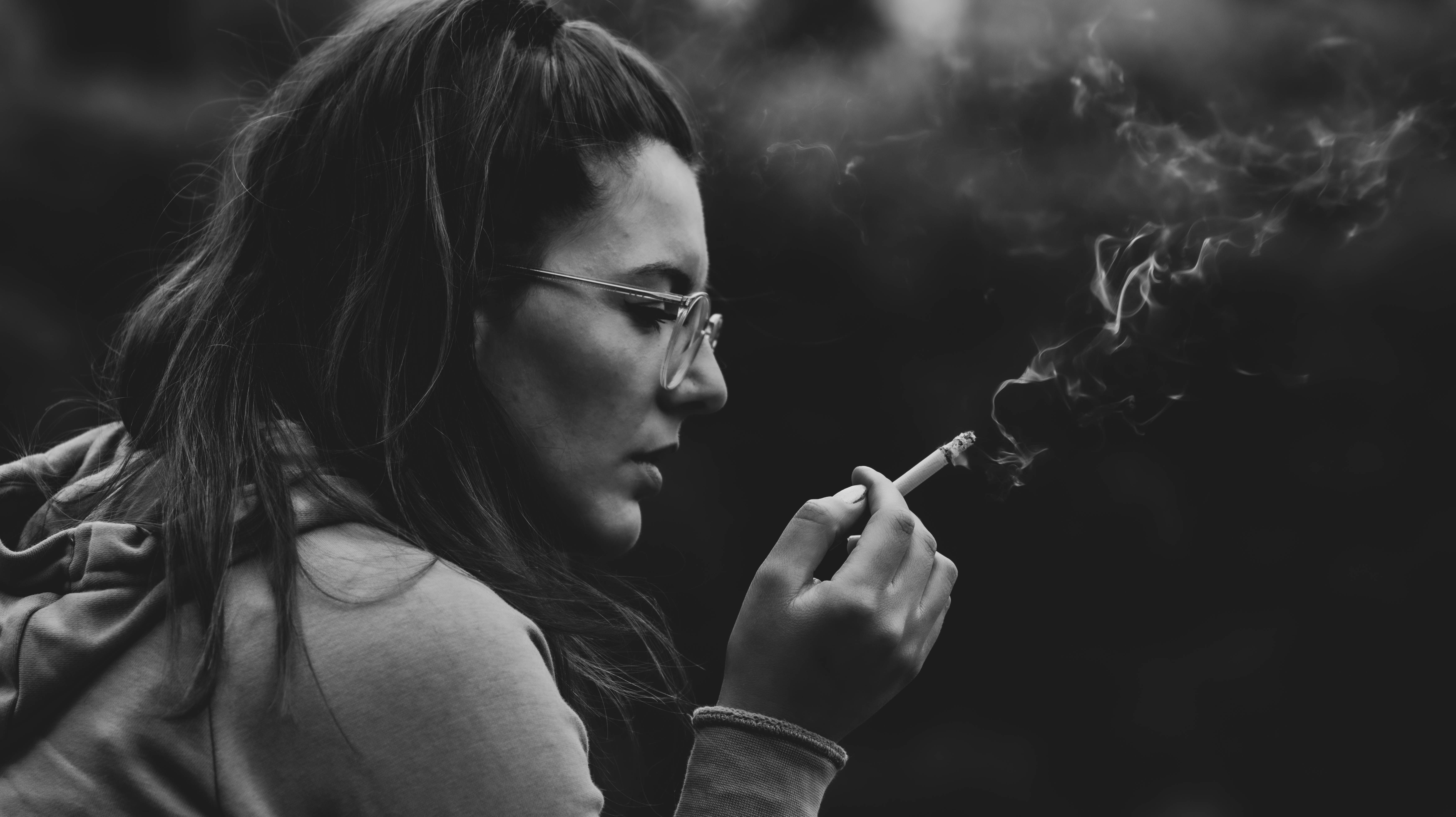 [ Woman with eyeglasses smoking a cigarette ]